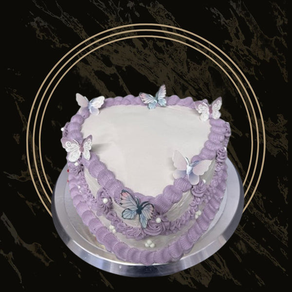 Butterfly Dream Heart cake with pastel-colored frosting, delicate butterfly decorations, and a heart-shaped design from The Bakers Shop in Birmingham