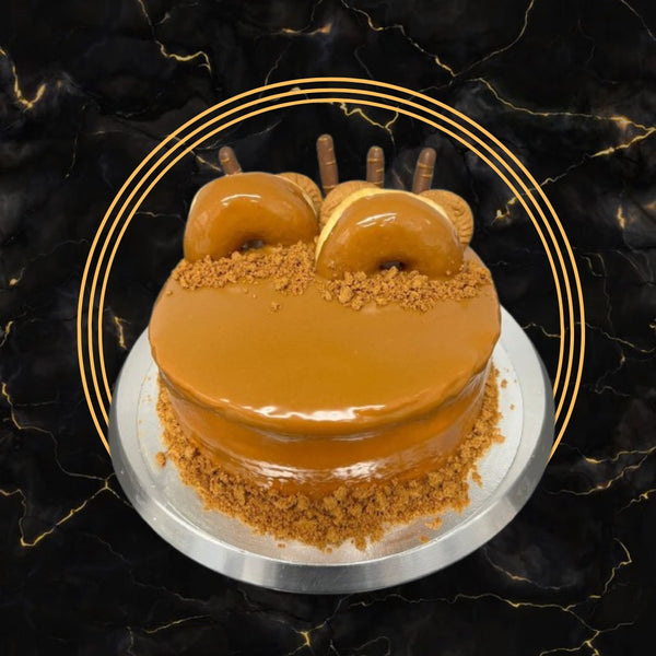 Biscoff Donut Drip Cake topped with glazed donuts, Biscoff crumbs, and caramel drip — The Bakers Shop Birmingham