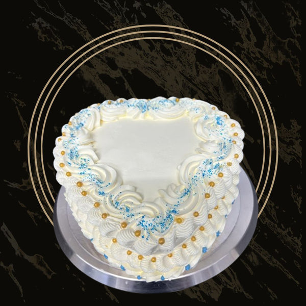 Blue Elegance Heart cake with rich blue frosting, intricate piping, and elegant design from The Bakers Shop in Birmingham