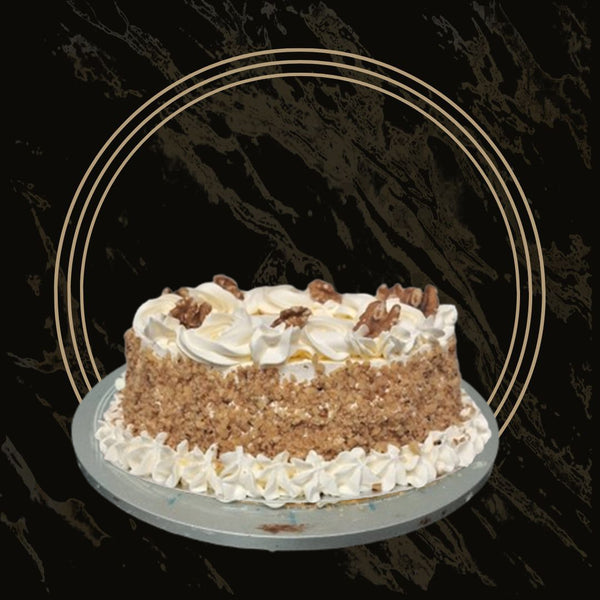 Deluxe carrot cake with extra nuts and thick frosting layers from The Bakers Shop in Birmingham