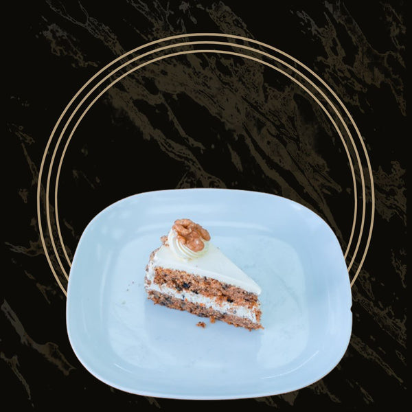 Moist carrot cake slices with cream cheese frosting and walnuts from The Bakers Shop in Birmingham