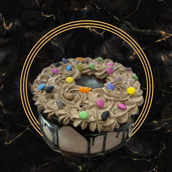 Chocolate Candy Swirl Cake topped with buttercream swirls, colorful candies, and ganache from The Bakers Shop Birmingham