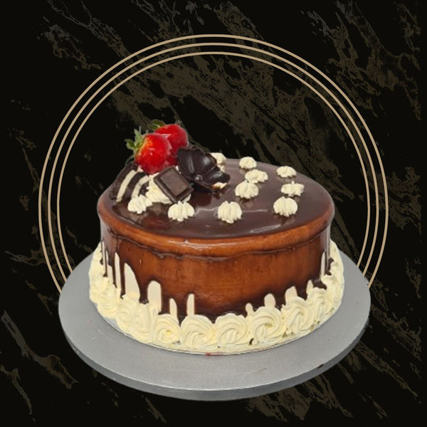 Fancy cake with gold drip and floral accents from The Bakers Shop in Birmingham