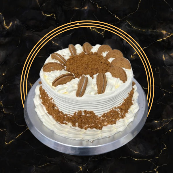 Lotus Biscoff cake topped with cream swirls and Biscoff biscuits