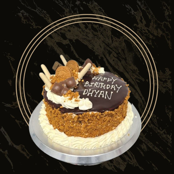 Loaded Lotus cake topped with whole biscuits, cream swirls, and caramel from The Bakers Shop in Birmingham