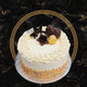 Vanilla celebration cake with fresh cream frosting, colourful sprinkles, chocolate flowers, and Ferrero Rocher topping
