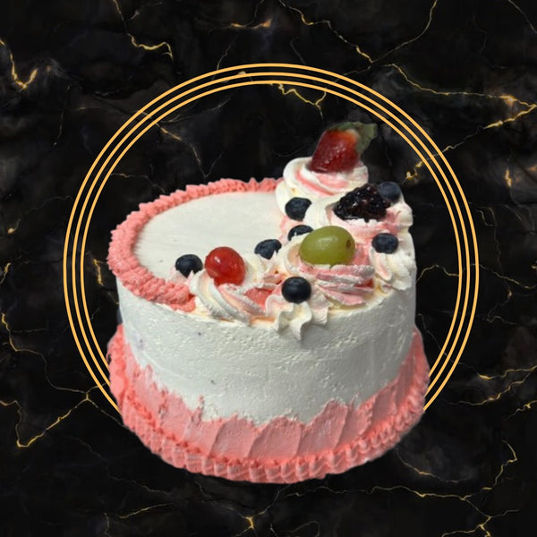 Pink and white fruit swirl cake topped with fresh fruits and whipped cream