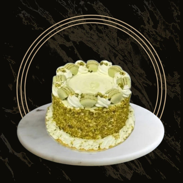 Round pistachio cake with smooth buttercream and nut garnish from 彩票联盟123赛车赛车官方网站 in Birmingham
